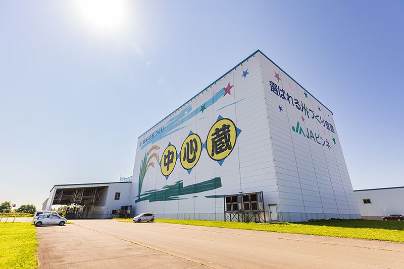 米穀乾燥調製貯蔵施設「中心蔵ライスターミナル」。側面に大きく「選ばれる米づくり宣言」を掲げる
